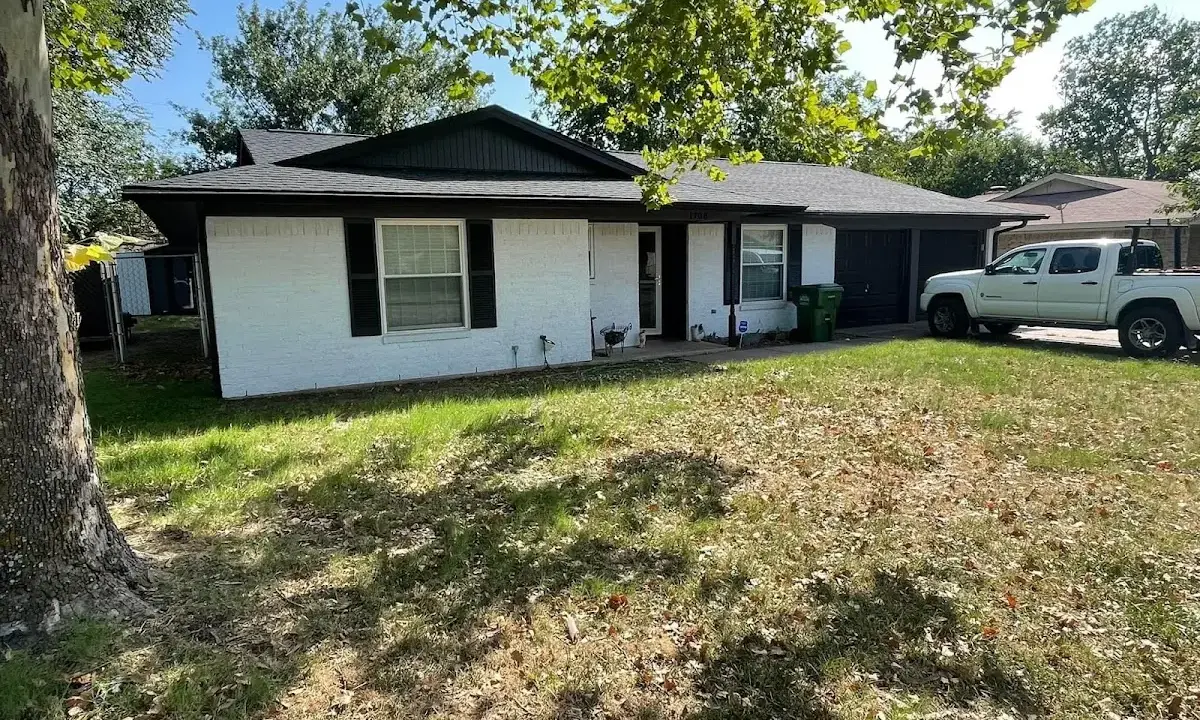 Professional roofing crew working on a residential roof in Falls
